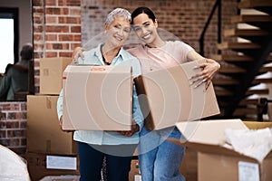 Time to fill a new home with memories. a senior woman moving house with help from her daughter.