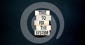 Time to fix the system symbol. Concept words Time to fix the system on wooden block. Beautiful black table black background.