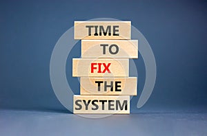 Time to fix the system symbol. Concept words Time to fix the system on wooden block. Beautiful grey table grey background.