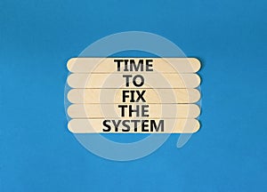 Time to fix the system symbol. Concept words Time to fix the system on wooden stick. Beautiful blue table blue background.