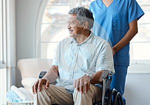 Time to get some fresh air. a handsome senior man and his female nurse in the old age home.