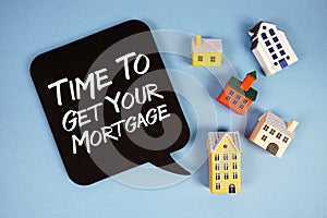 Time To Get Your Mortgage text with house models on blue background