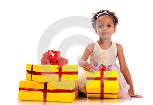 Time to give presents! Young girl with curly hair and yellow gift box on white background