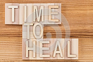 Time to heal- text in vintage letters on wooden blocks. Medicin