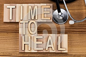 Time to heal- text in vintage letters on wooden blocks. Medicin