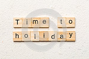 Time to holiday word written on wood block. Time to holiday text on cement table for your desing, concept