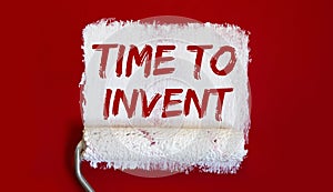 TIME TO INVENT.One open can of paint with white brush on red background. Top view