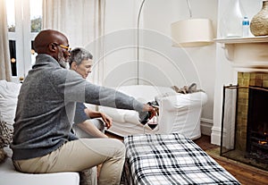 Time to lay back and relax with my love. an affectionate senior couple enjoying some wine together at home.