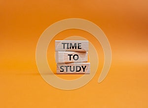Time to learn symbol. Wooden blocks with words Time to learn. Beautiful orange background. Business and Time to learn concept.