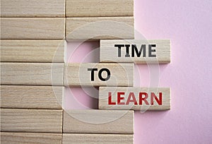 Time to learn symbol. Wooden blocks with words Time to learn. Beautiful pink background. Business and Time to learn concept. Copy