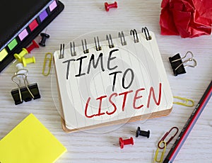 Time to listen symbol. Concept words Time to listen on white notebook. Beautiful wooden background. Business and Active listening