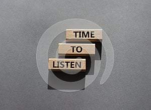 Time to listen symbol. Wooden blocks with words Time to listen. Beautiful grey background. Business and Active listening concept.