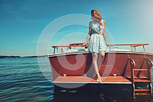 Time to live life at a slower pace. an attractive young woman spending the day on her private yacht.