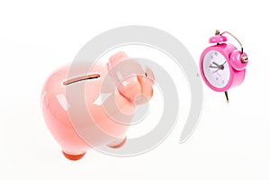 It is time to pay. Piggy bank pink pig and little alarm clock. Financial crisis. Banking account. Bankruptcy and debt