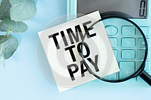 TIME TO PAY - text next to the calculator on the notepad. The concept of time to pay a loan or debt.