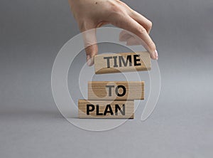 Time to plan symbol. Wooden blocks with words Time to plan. Beautiful grey background. Businessman hand. Business and Time to plan