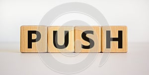 Time to push. Wooden block form the word `push` on beautiful white background. Business and push concept. Copy space