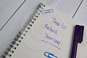 Time To Reboot Yourself write on a book isolated on office desk