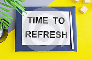 TIME TO REFRESH text written in Notebook, bsiness concept, yellow background