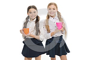Time to relax. Schoolgirls with mugs having tea break. Relax and recharge. Water balance concept. Enjoying tea together