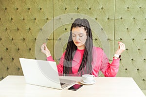 Time to relax! Successful young girl freelancer with black dreadlocks hairstyle in pink blouse are having a rest, holding hands