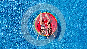 Time to relax. Top view of attractive young woman in bikini smiling while relaxing in the pool with girlfriend