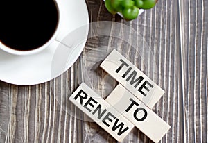 Time to renew text on a wooden cubes on a wooden background