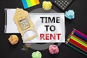 Time to rent real estate symbol. White note, words `time to rent` on beautiful black background, metalic pen, calculator, colore