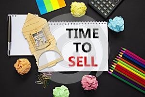 Time to rent sell estate symbol. White note, words `time to sell` on beautiful black background, metalic pen, calculator, colore