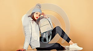time to rest. girl in puffed coat. faux fur fashion. warm winter clothing. shopping. woman in beanie hat with backpack