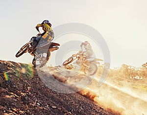 Time to rip up this track. A shot of two dirtbike racers going head-to-head on the track.