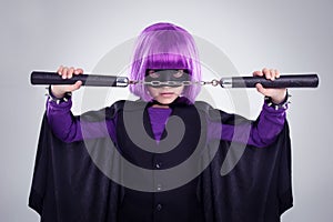 Time to save the day. A studio shot of a confident little girl playing dress-up.