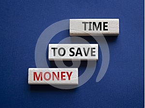 Time to save money symbol. Wooden blocks with words Time to save money. Beautiful deep blue background. Business and Time to save