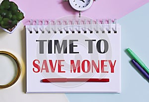 TIME TO SAVE MONEY text written on a notebook with pencils, magnifier