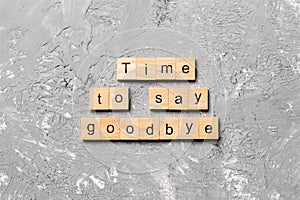 Time to say goodbye word written on wood block. Time to say goodbye text on cement table for your desing, concept