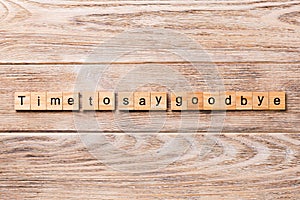 Time to say goodbye word written on wood block. Time to say goodbye text on wooden table for your desing, concept