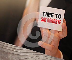 Time to Say Goodbye words on a card in hand of businessman. Business agreement termination concept