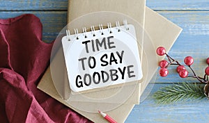 TIME TO SAY GOODBYE is written on a notepad