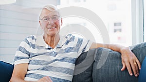 Time to slow things down. a senior man relaxing on the sofa at home.