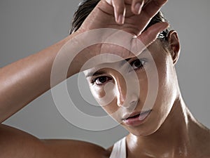 Time to take a break. Portrait of a confident young woman wiping her forehead after a strenuous workout.