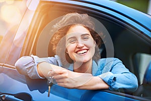 Time to take my new baby for a spin. a happy young woman holding the keys to a new car.