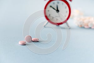Time to take pills. Alarm clock  and pills. Right time for using medicines
