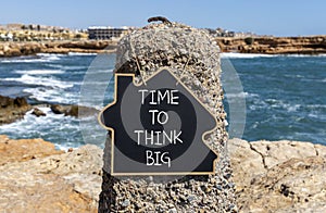 Time to think big symbol. Concept words Time to think big on beautiful black chalk blackboard. Beautiful stone blue sea sky