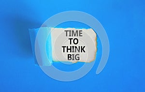 Time to think big symbol. Concept words Time to think big on beautiful white paper. Beautiful blue background. Business and time