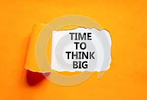 Time to think big symbol. Concept words Time to think big on beautiful white paper. Beautiful orange background. Business and time