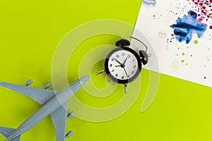 Time to travel concept. plastic plane jet toy passenger with alarm clock