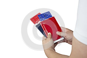 Time To Travel. Guy holds plane tickets and passports in hands isolated on white background