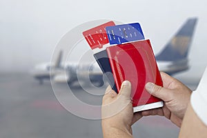 Time To Travel. A man is holding tickets and passports in the background of the plane