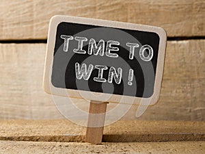 Time to win. Business Concept. text write on Chalkboard at wooden background