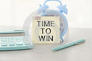TIME TO WIN. Text on white sheet of notepad
